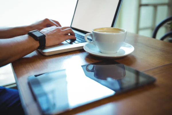 man-using-laptop-while-having-coffee
